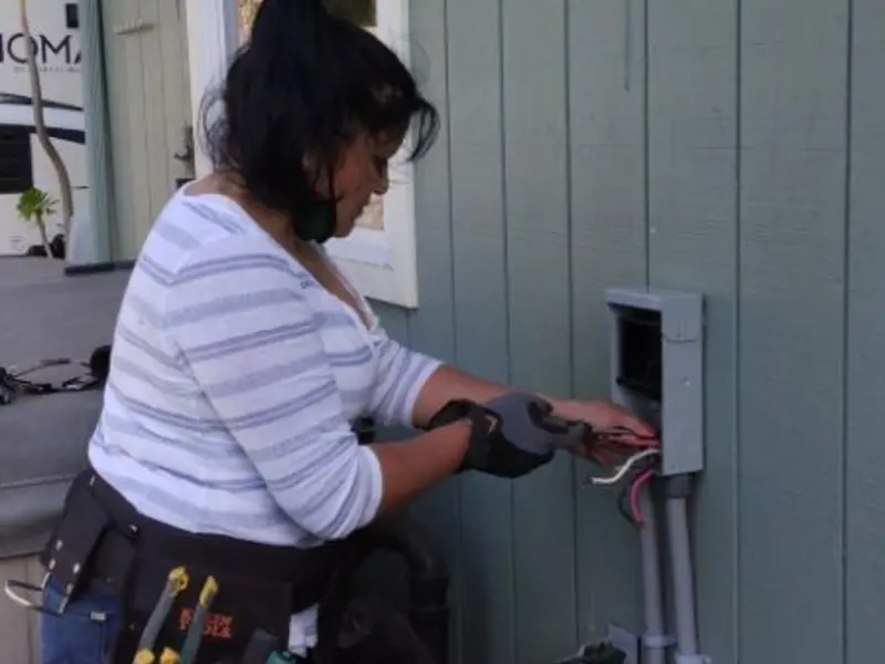 Licensed electrician wiring an exterior subpanel in Eagan